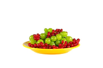 red currants and grapes in a bowl isolated on white