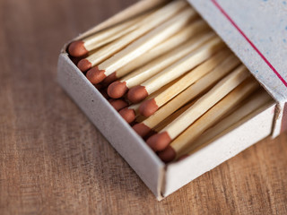 Wooden matches on a wooden table background