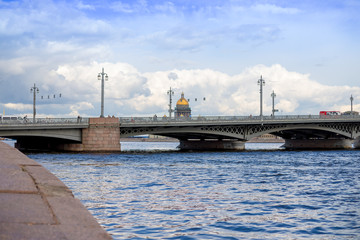View of the summer city with cloudly sky. In the foreground Blagoveshchensky bridge in St. Petersburg. In the background, the main attractions. the Palace Bridge and St. Isaac sobo. Russia, Saint
