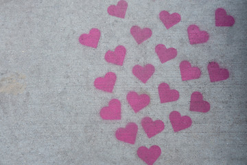 Many red sidewalk chalk hearts. Valentine day concept.