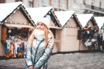 Fototapeta premium Young beautiful girl walking at the Christmas Fair