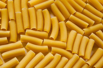 Uncooked pasta Rigatoni on wooden background. Cooking concept. Top view - Image