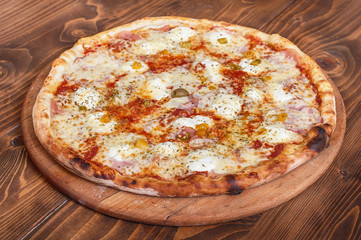 Pizza margherita on wooden background, side view