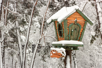 A small tree house in a snowy forest on a clear winter frosty day