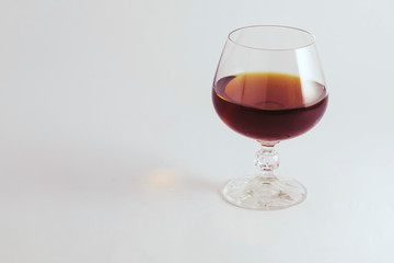 cognac in a crystal glass on a white background