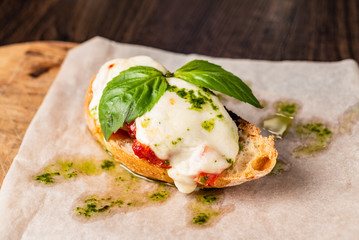 Traditional italian bruschetta with cherry tomatoes, cream cheese, basil leaves