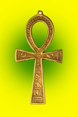 Egyptian symbol of life Ankh on yellow green background. Close up image.