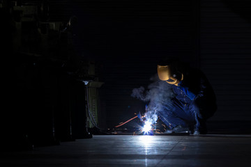 Working person About welder steel Using electric welding machine There are lines of light coming...