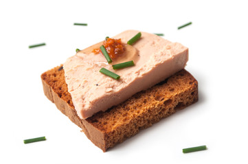 closeup of foie gras on gingerbread on white background