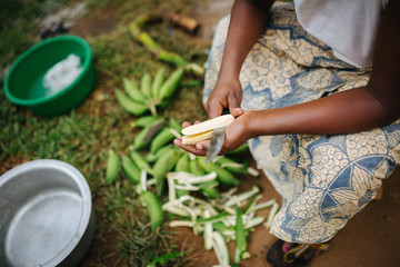 woman preparing bananas for cooking in Uganda, Africa