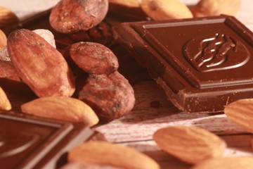 cacao beans and chocolate on wooden background