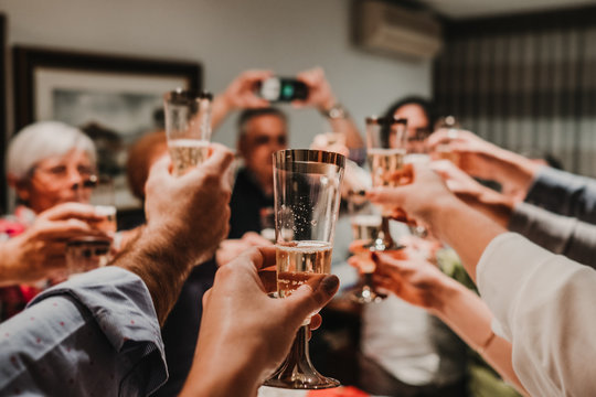 .Large group of family celebrating moments together, toasting with champagne at a special time. Happy New Year. Lifestyle