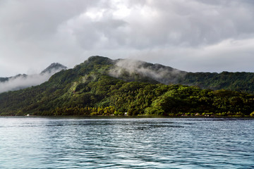 Rainforests on the mountains in the misty clouds of the island Moorea in the Leeward group of the Society Islands of French Polynesia.