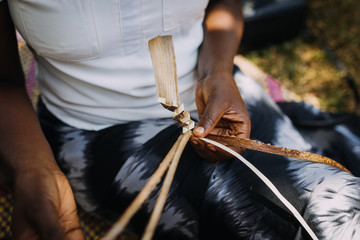 woman weaving banana leaves in Uganda, Africa