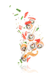 Pieces of fresh sushi with chopsticks frozen in the air