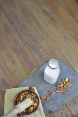 Homemade Almond milk in bottle with almonds in a bowl. Dairy alternative milk - close up with space for text