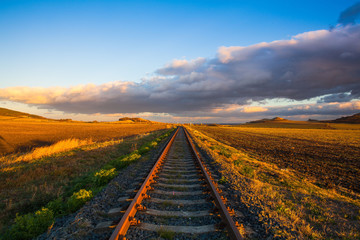 Single railway track at sunset, Czech Republic.