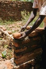 Man building a wall in Uganda, Africa