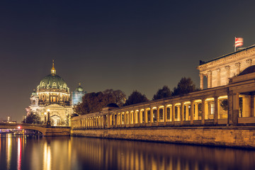 Fototapeta premium Berlin at night. Berlin Cathedral and the Friedrich's Bridge with lighting and reflections in the river Spree. illuminated arcade of the national gallery in autumn mood
