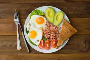 Healthy breakfast. Avocado, eggs sandwich with whole grain bread on wooden background. Copy space