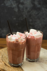 Coffee drink, cocoa with chocolate sauce vanilla cream and marshmallows on wooden table and grounge background