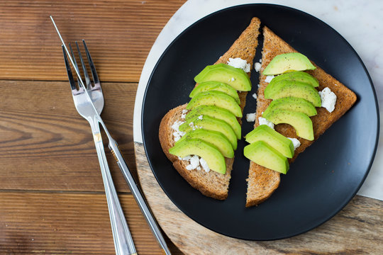 Breakfast Sandwich On Toast Bread Made With Fresh Sliced Avocado, Cream Cheese And Seeds, From Above