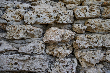 Stone wall of cement-bound sedimentary rocks