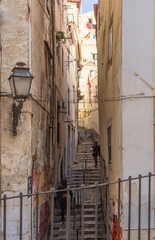 Fototapeta premium Lisbon - Portugal. a narrow stone staircase leads into the ancient Alfama district