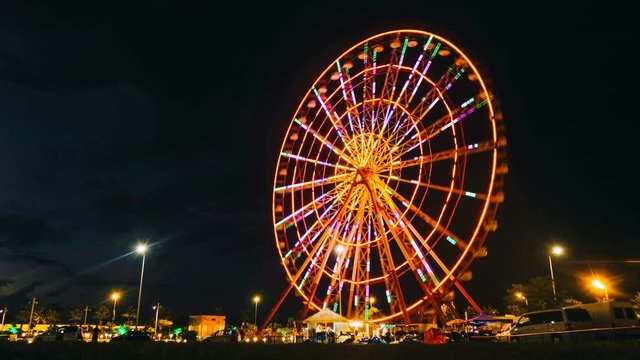 Time lapse ferris wheel on a sunset background on the sea