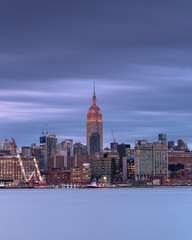Fototapeta premium View on Empire state building from hudson river at night with long exposure