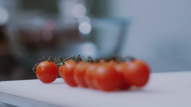 Close up fresh red cherry tomatoes on table slow motion vegetable diet healthy vegetarian summer break