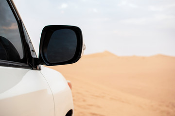 Fototapeta na wymiar Side mirror of a car in a desolate landscape