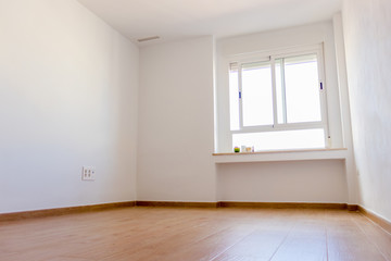 empty white room with window with lots of light