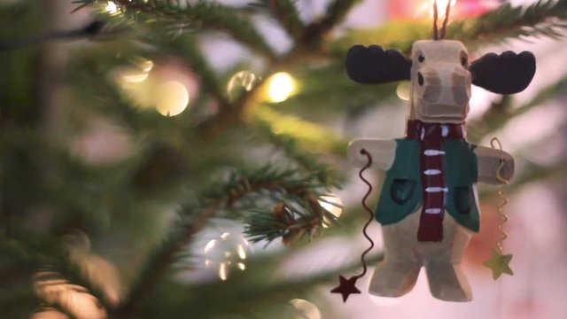Beautiful Christmas Fir Tree Toy in Shape Funy Deer. Christmas Tree With Defocused Blurred Lights Bokeh. Christmas Tree With Bokeh Background.