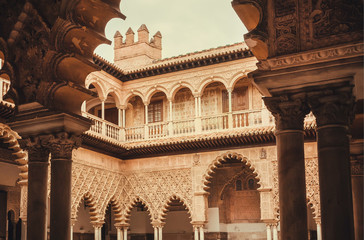 Fototapeta premium Pattenes of the arches inside Alcazar royal palace in Mudejar architecture style, Seville