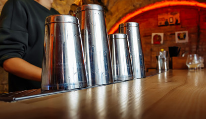Tools for making cocktails, shakers. The barman is preparing basic drinks.