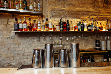 Tools for making cocktails, shakers. The barman is preparing basic drinks.