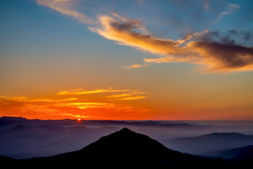 Fototapeta na wymiar Silhouetted Peak at Sunset