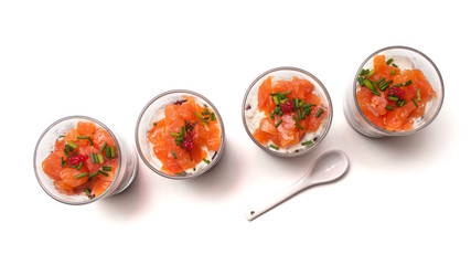 closeup of  salmon appetizers in little glasses on top view on white background