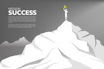 silhouette of businesswomen with the winner trophy standing on the top of mountain. Concept of Goal, Mission, Vision, Success in Career path.