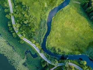 Aerial Photo of Road going by the River under the Trees, Top Down View in Early Spring on Sunny Day