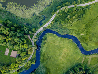 Aerial Photo of Road going by the River under the Trees, Top Down View in Early Spring on Sunny Day