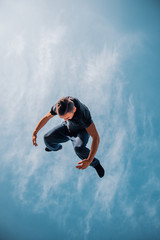 Obraz premium Parkour man in action while doing parkour tricks