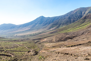 Hiking on Jandia Peninsula, Fuerteventura, Canary Islands, Spain. Mountains in this area (Jandia Massif) divided by deep valleys (barrancos). Fuerteventura is a desert island, the oldest of Canaries