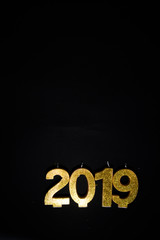 New Years Eve celebration background , 2019 number made with golden glitter candles, flatlay over a green board, luxury  holiday concept,