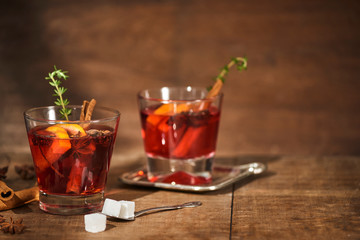 Autumnal concept with cup of tea with lemon, cinnamon stick and anise star on rustic wooden background