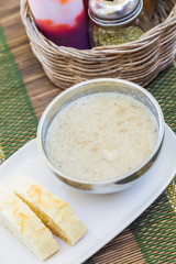 Creamy hot musroom soup served with bread on the table