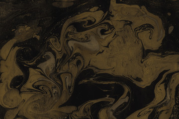 Luxury gold marble ink paper texture on dark watercolor background. Chaotic abstract organic design. Bath bomb waves.