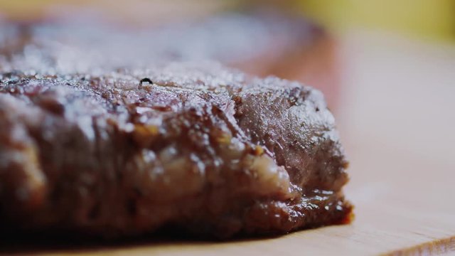 Beef steak cooked medium well cut sliced knife on a cutting board roast fillet red barbecue dinner gourmet grill restaurant beefsteak delicious dish fire lunch meal appetite slow motion