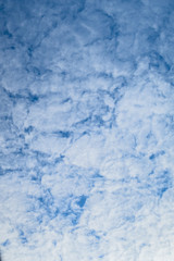 blue background of sky with fluffy clouds